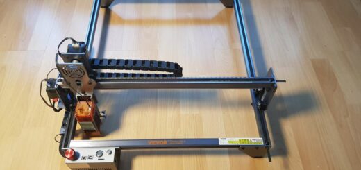 Partially assembled VEVOR laser engraver on a hardwood floor